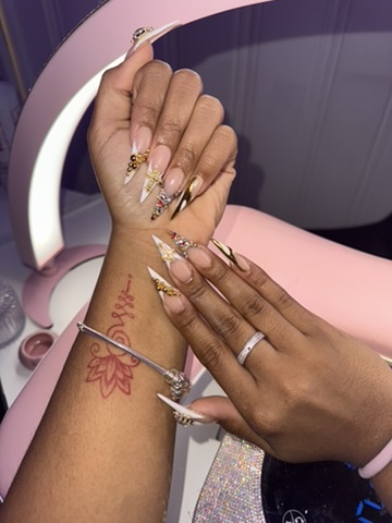 Long stiletto nails with rhinestone and gold accents