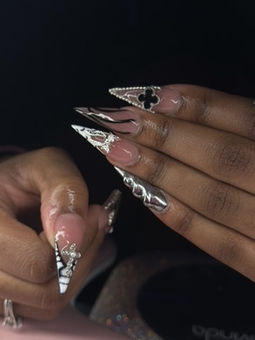 Black and silver stiletto nails with rhinestone accents
