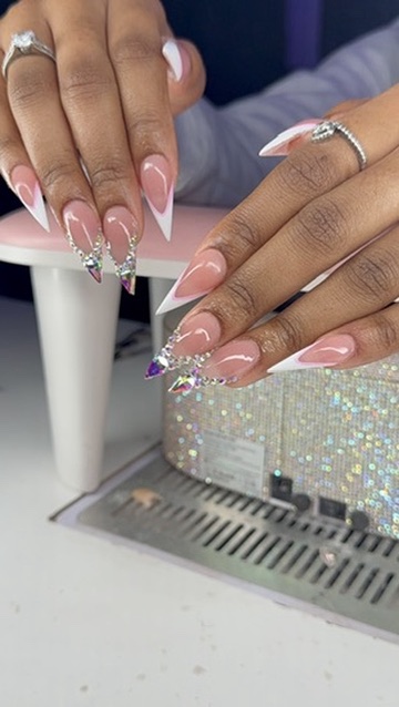 Pink and white French nails with rhinestone accents