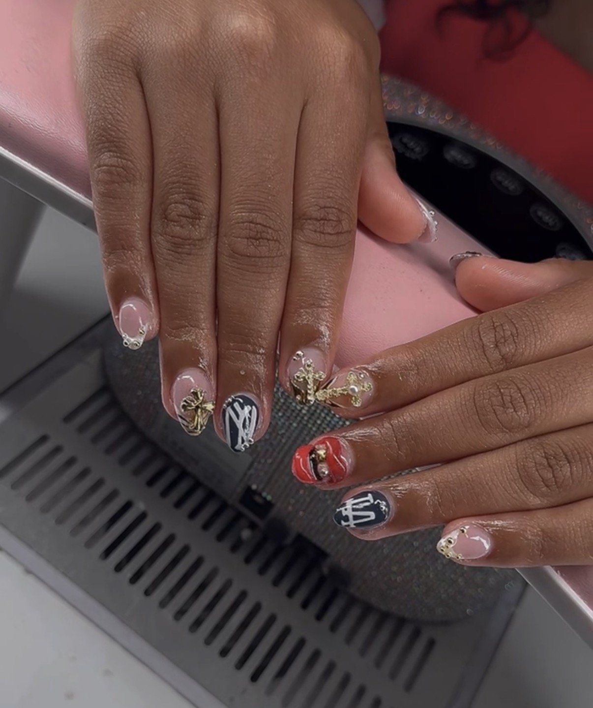 Short mixed charm nail set with black red and gold details